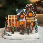 MOMENTS IN TIME Christmas Village Building, Christmas Shop with Snowman, LED Lights and Music - Battery Operated (not Included) Adapter Included (8.5" H x 9.8" W x 6.9" D)